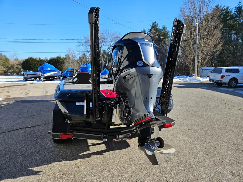 Slide: The Image of 2025 Skeeter ZXR21 boat with powerful outboard motor, parked on a sunny day. - 5