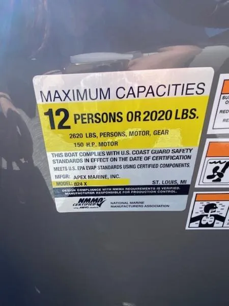 Slide: The Image of Capacity label on 2023 Qwest 824 E-Class Splash Pad Rw LTZ boat, max 12 persons or 2020 lbs. - 12