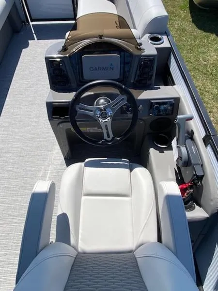 Slide: The Image of 2023 Qwest 824 E-Class Splash Pad Rw LTZ boat interior with steering wheel and Garmin display. - 4