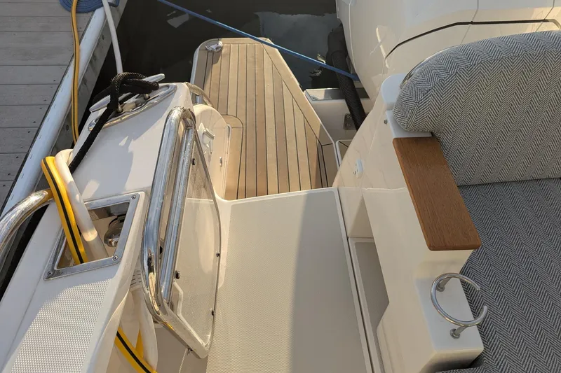 Slide: The Image of 2024 Back Cove 39O boat deck with seating and wooden accents. - 10