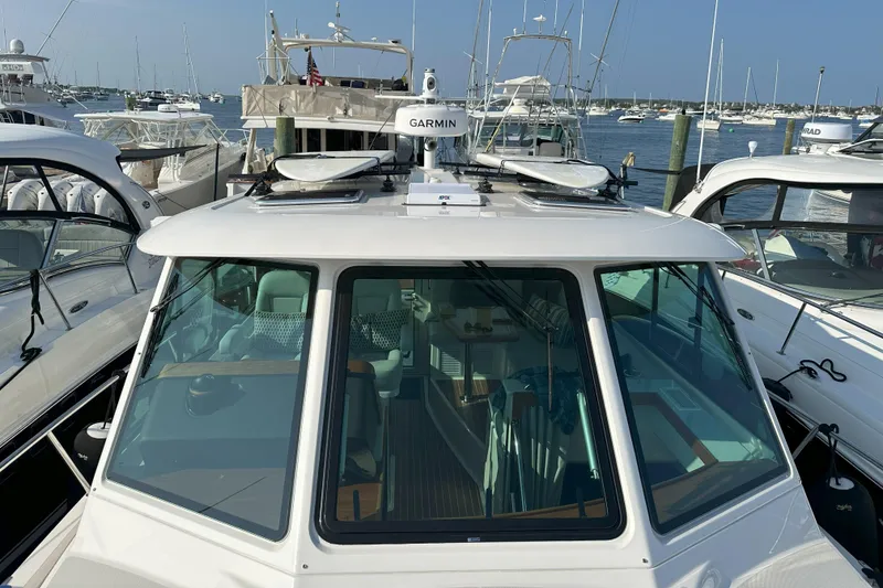 Slide: The Image of 2024 Back Cove 39O boat docked, featuring Garmin equipment and sleek design. - 11