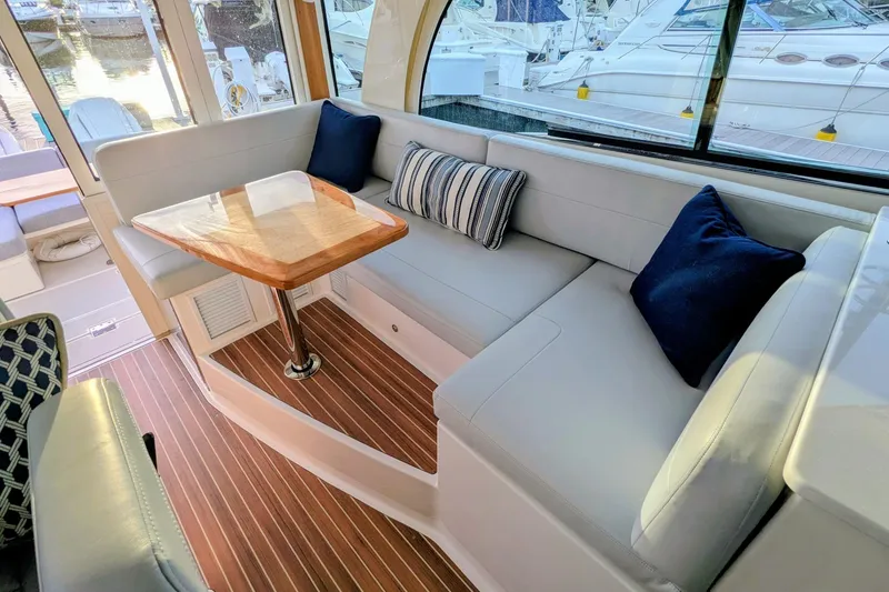 Slide: The Image of Luxurious interior of 2024 Back Cove 39O yacht with elegant seating and wooden table. - 24