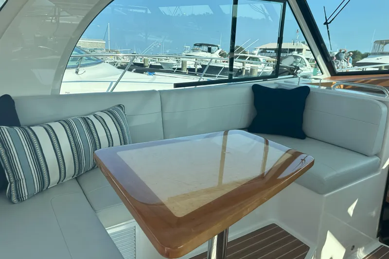 Slide: The Image of Luxurious interior of 2024 Back Cove 39O yacht with elegant seating and wooden table. - 25