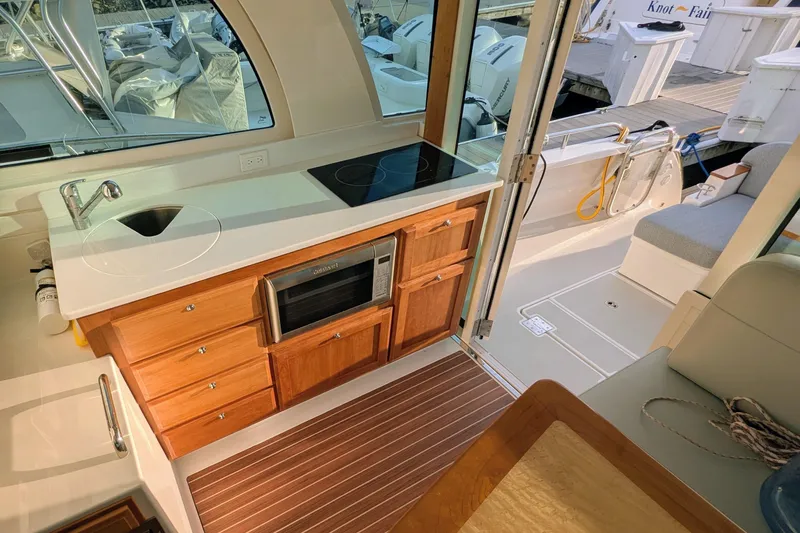 Slide: The Image of 2024 Back Cove 39O yacht interior with kitchenette, featuring sink, stove, and microwave. - 26