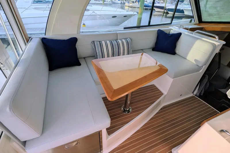 Slide: The Image of 2024 Back Cove 39O yacht interior with elegant seating and wooden table. - 27