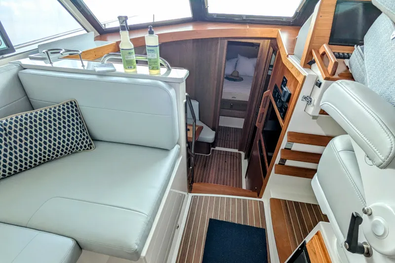 Slide: The Image of 2024 Back Cove 39O interior with modern seating and wooden accents. - 29