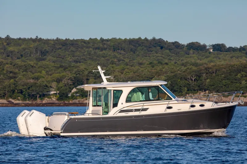 Slide: The Image of 2024 Back Cove 39O boat docked in calm waters, showcasing sleek design and modern features. - 3