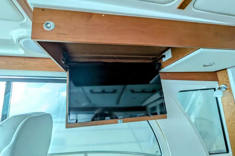 Slide: The Image of 2024 Back Cove 39O yacht interior with retractable TV in wooden cabinet. - 30