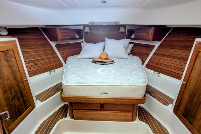 Slide: The Image of 2024 Back Cove 39O cabin interior with bed, wooden accents, and cozy decor. - 35