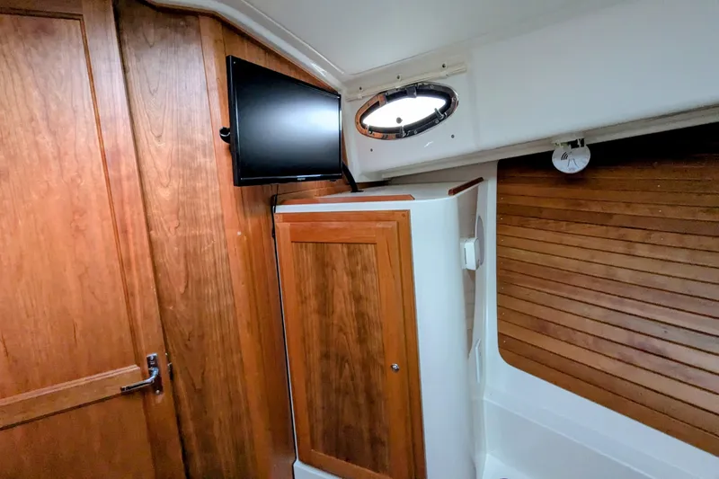 Slide: The Image of 2024 Back Cove 39O interior with wood paneling and mounted TV. - 38