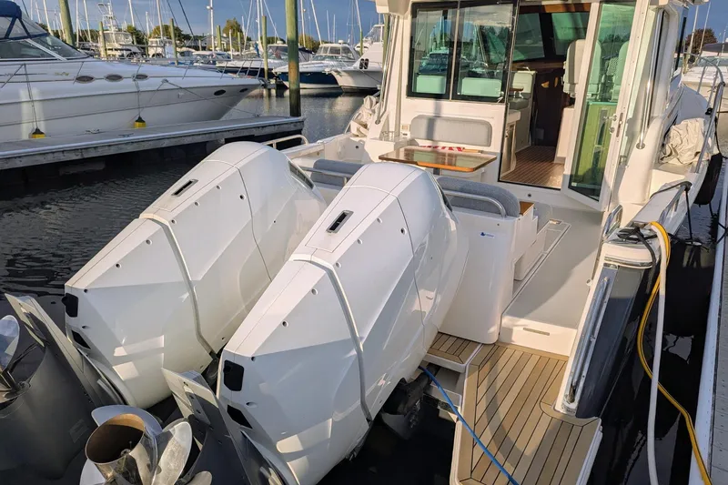 Slide: The Image of 2024 Back Cove 39O boat with dual outboard engines docked at marina. - 7