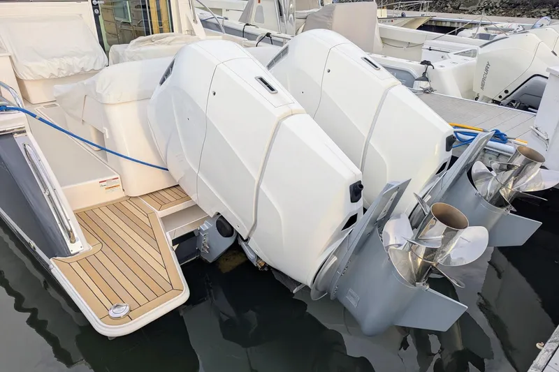 Slide: The Image of 2024 Back Cove 39O boat with dual outboard engines docked at marina. - 9