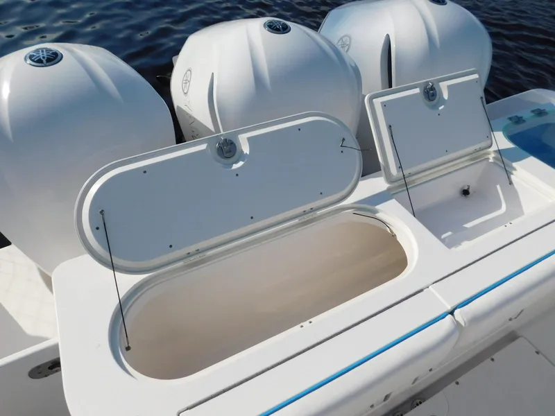 Slide: The Image of 2016 Everglades 355 Center Console boat with open storage compartments and powerful engines. - 11