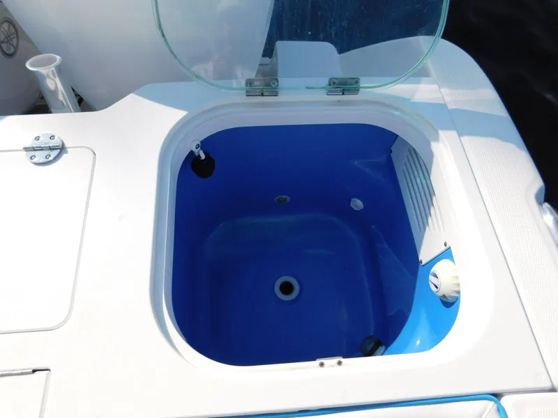 Slide: The Image of Livewell on 2016 Everglades 355 Center Console boat, open lid, blue interior. - 14