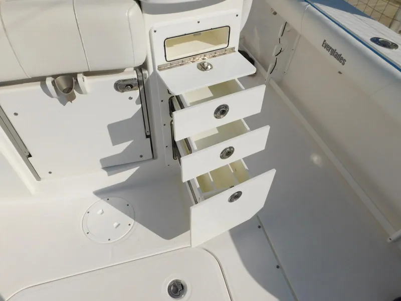 Slide: The Image of 2016 Everglades 355 Center Console boat with open storage drawers in white interior. - 18