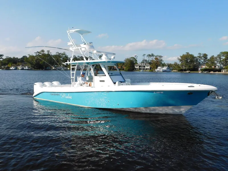 Slide: The Image of 2016 Everglades 355 Center Console boat on calm water, blue and white design. - 23