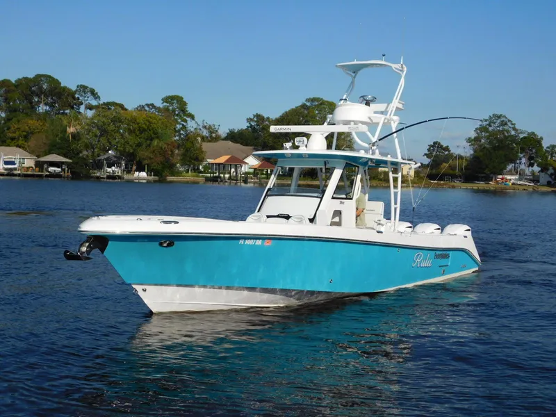 Slide: The Image of 2016 Everglades 355 Center Console boat on calm water, blue and white design. - 28