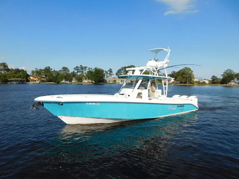 Slide: The Image of 2016 Everglades 355 Center Console boat on calm water, blue and white design. - 29