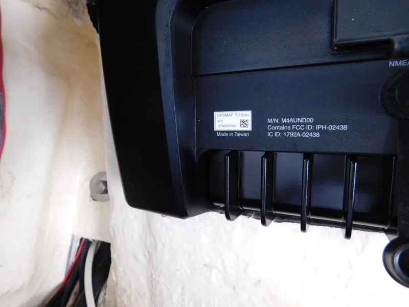 Slide: The Image of Close-up of a 2016 Everglades 355 Center Console component with FCC and IC ID labels. - 34