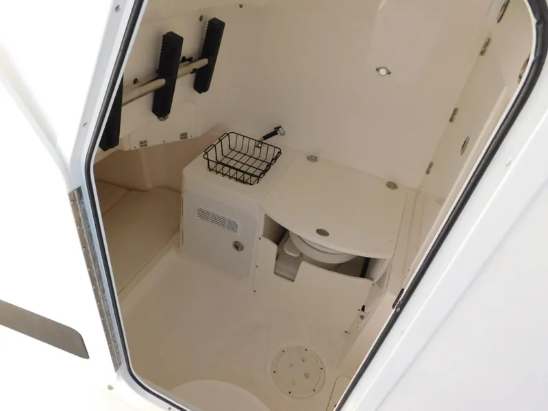 Slide: The Image of 2016 Everglades 355 Center Console interior cabin with toilet and storage. - 35