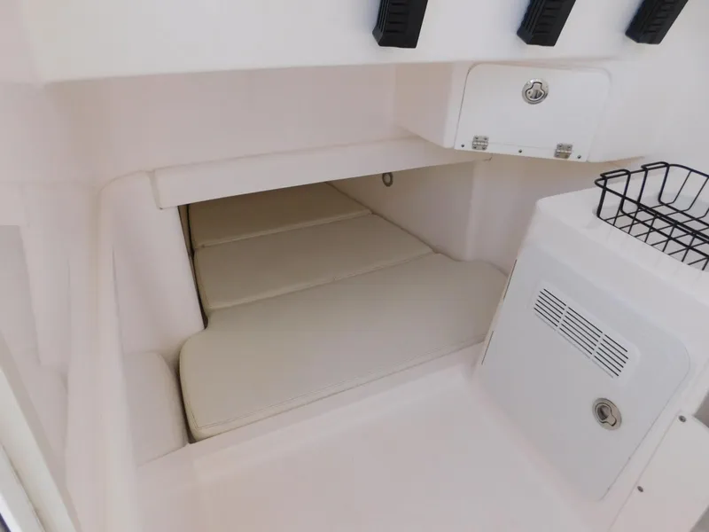 Slide: The Image of 2016 Everglades 355 Center Console cabin interior with cushioned seating and storage compartments. - 37