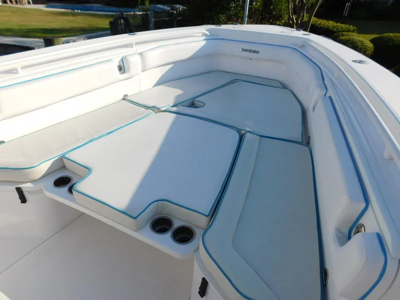 Slide: The Image of 2016 Everglades 355 Center Console boat interior with cushioned seating and cup holders. - 45
