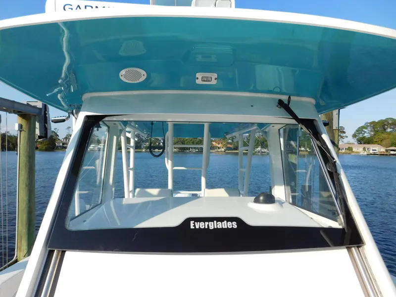 Slide: The Image of 2016 Everglades 355 Center Console boat on water, showcasing helm and windshield. - 49
