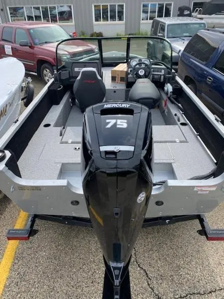 Slide: The Image of 2022 Alumacraft Competitor 165 Sport boat with Mercury 75 engine, parked outdoors. - 5