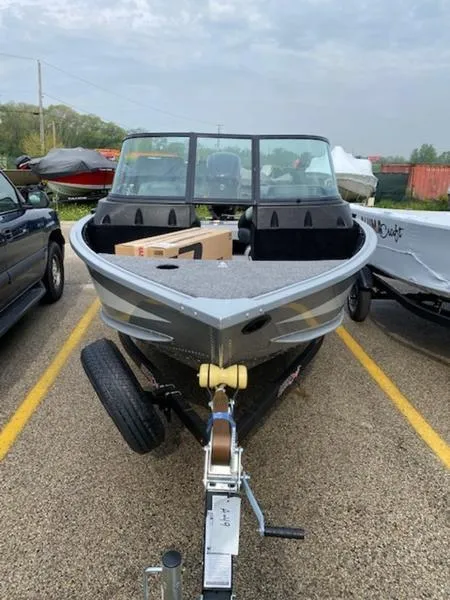 Slide: The Image of 2022 Alumacraft Competitor 165 Sport boat on trailer in parking lot. - 6