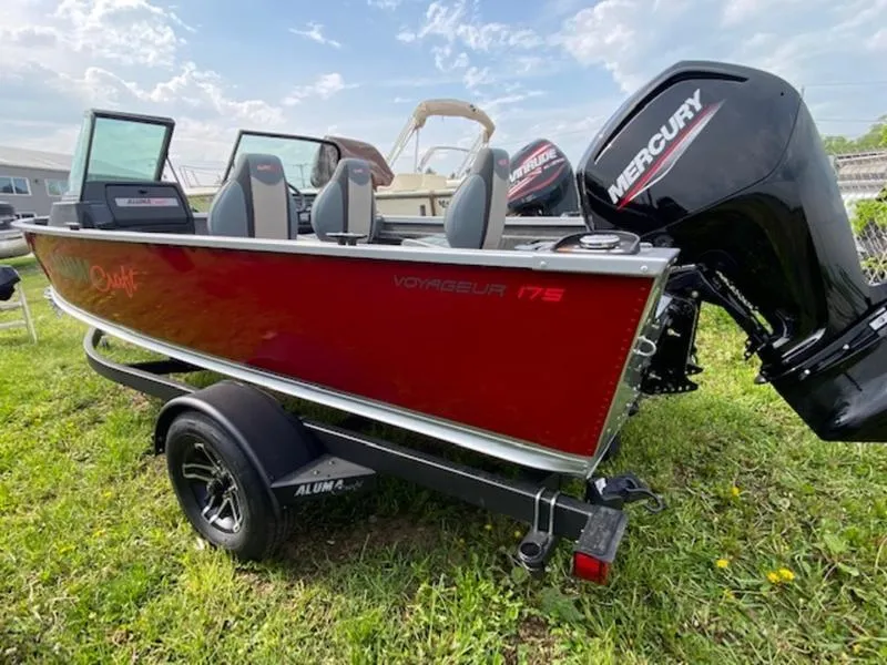 Slide: The Image of 2022 Alumacraft Voyageur 175 Sport boat with Mercury engine on grassy area. - 1