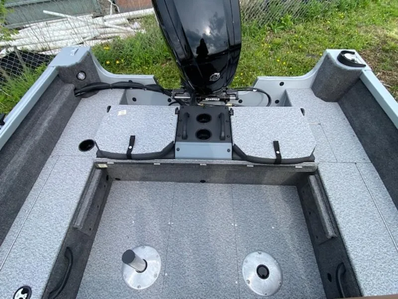 Slide: The Image of 2022 Alumacraft Voyageur 175 Sport boat interior with motor and seating area. - 4