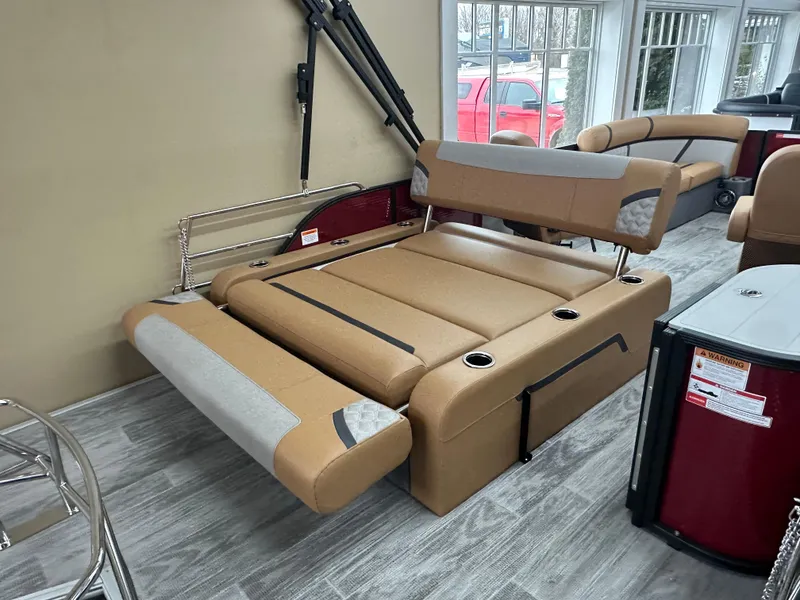 Slide: The Image of 2025 Crest Classic 200 boat interior with tan seating and cup holders. - 11