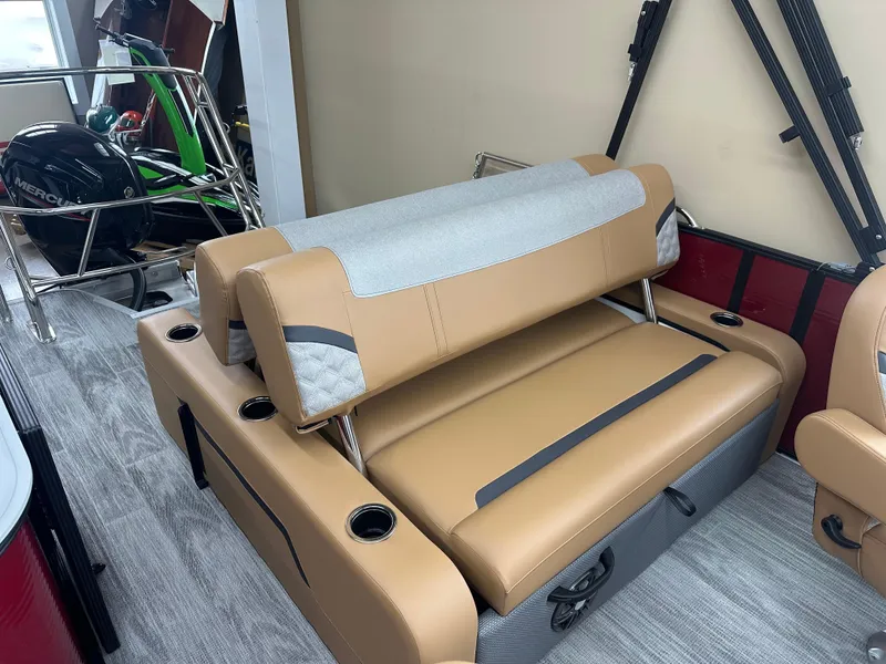 Slide: The Image of 2025 Crest Classic 200 boat interior with tan and gray seating, featuring cup holders. - 9