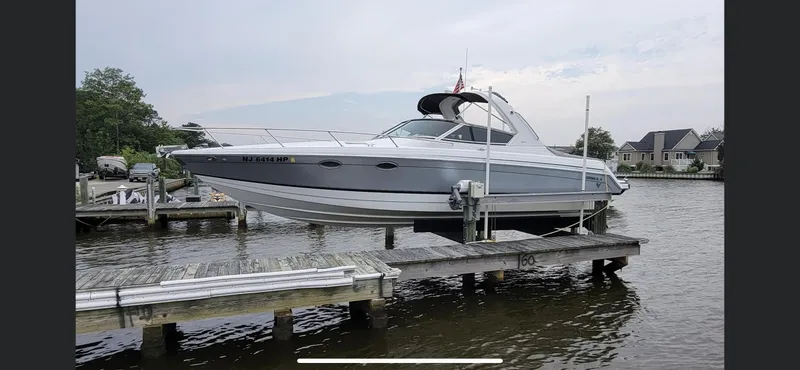 The Image of 2005 Formula 330 Sun Sport boat docked on a lift by the water. - 0