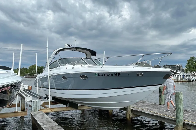 Slide: The Image of 2005 Formula 330 Sun Sport boat docked under cloudy skies. - 2