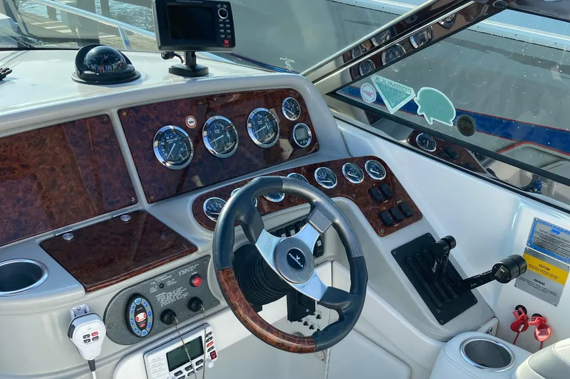 Slide: The Image of 2005 Formula 330 Sun Sport boat dashboard with gauges and steering wheel. - 3