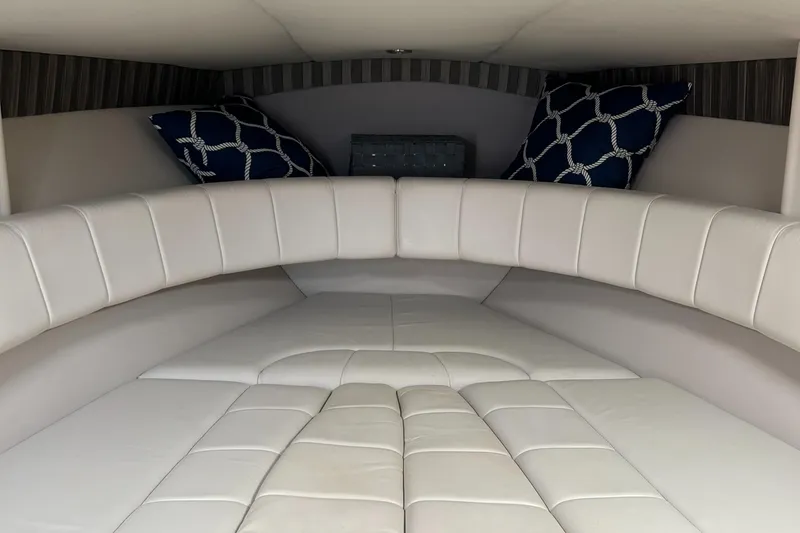 Slide: The Image of 2005 Formula 330 Sun Sport cabin interior with white leather seating and decorative pillows. - 4