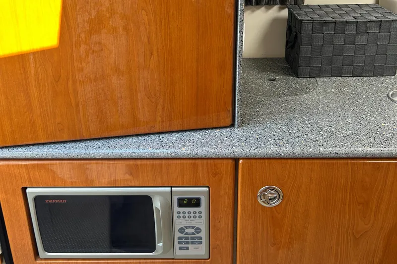 Slide: The Image of 2005 Formula 330 Sun Sport interior with microwave and wooden cabinetry. - 7