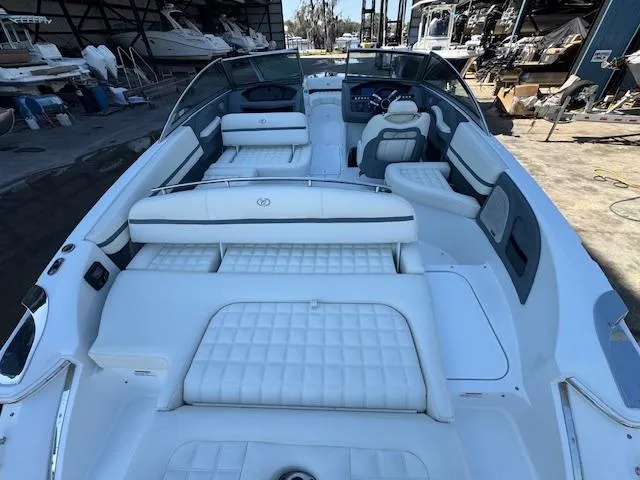 Slide: The Image of 2018 Cobalt R3 boat with spacious white seating and sleek design in a marina setting. - 11