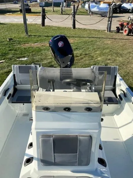 Slide: The Image of 2023 Lowe Bay20 boat with center console and outboard motor, parked on grass. - 12