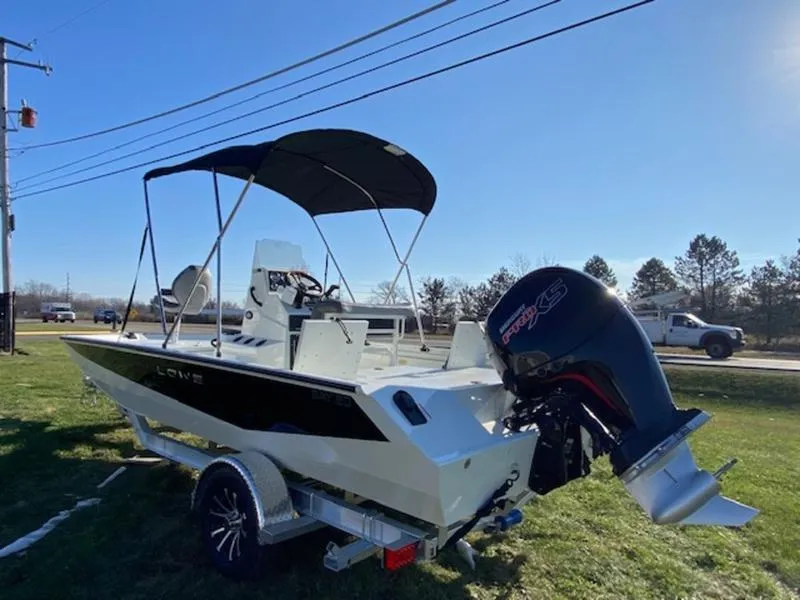 Slide: The Image of 2023 Lowe Bay20 boat with canopy and outboard motor on a trailer. - 3