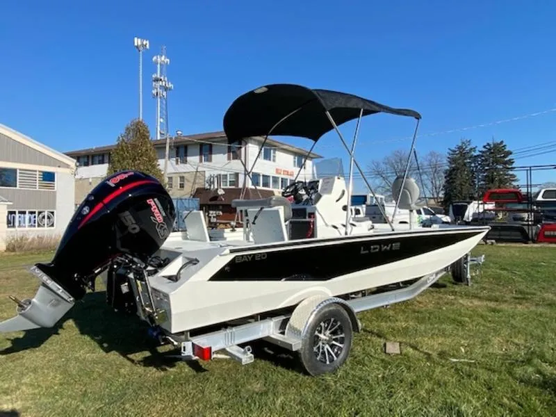 Slide: The Image of 2023 Lowe Bay20 boat with canopy on trailer, parked outdoors. - 4