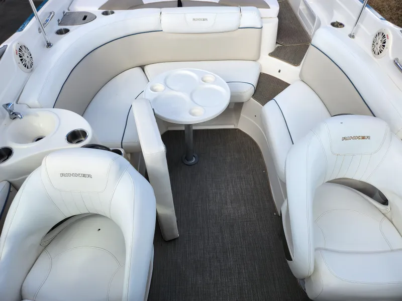 Slide: The Image of 2007 Rinker 246 Captiva Cuddy boat interior with white seating and round table. - 15
