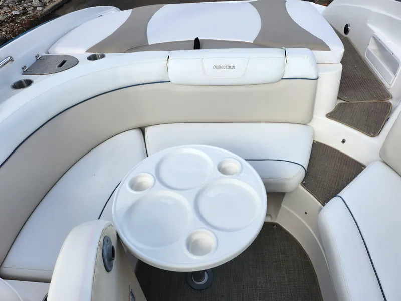 Slide: The Image of 2007 Rinker 246 Captiva Cuddy interior with seating and table. - 16
