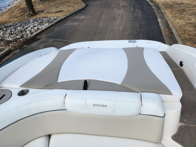 Slide: The Image of 2007 Rinker 246 Captiva Cuddy boat interior with cushioned seating and sleek design. - 17
