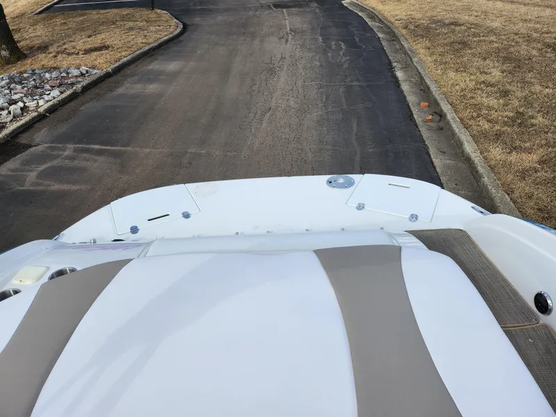 Slide: The Image of 2007 Rinker 246 Captiva Cuddy boat on a paved road, top view. - 18