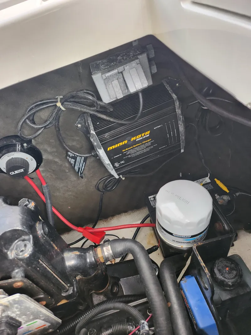 Slide: The Image of Engine compartment of a 2007 Rinker 246 Captiva Cuddy boat, showing wiring and components. - 20