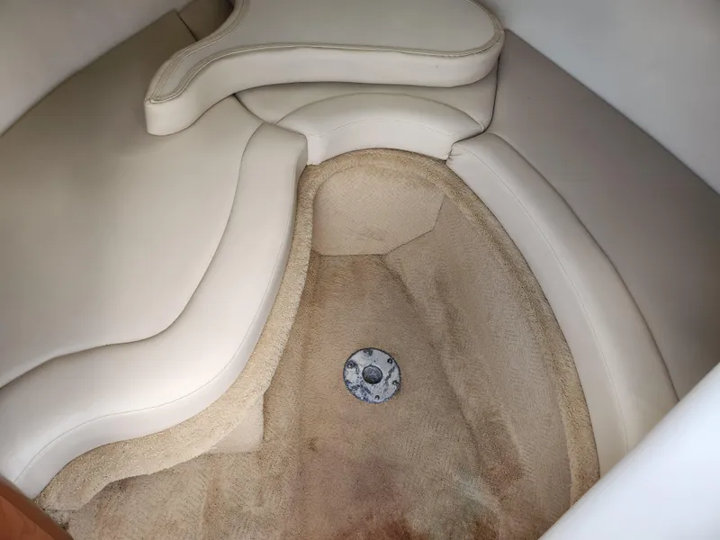 Slide: The Image of 2007 Rinker 246 Captiva Cuddy interior with beige upholstery and carpeted flooring. - 21