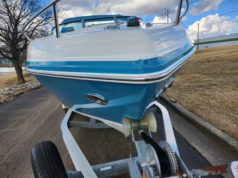 Slide: The Image of 2007 Rinker 246 Captiva Cuddy boat on trailer, blue and white hull, outdoor setting. - 6
