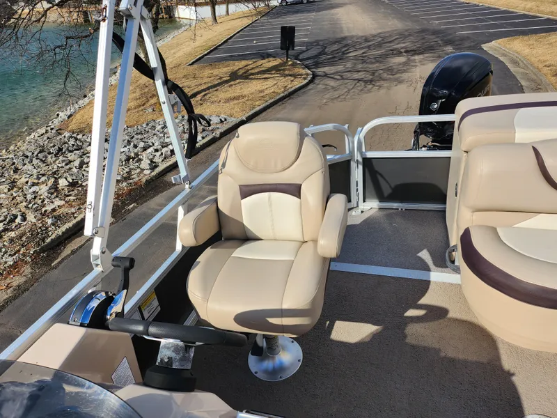 Slide: The Image of 2015 Sun Tracker Party Barge 20 DLX with beige seating and steering wheel. - 14